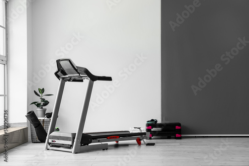 Принти на полотні Modern treadmill with towels and skipping room in gym