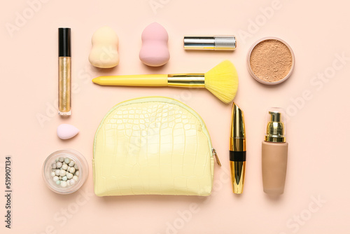 Composition with bag, cosmetics and makeup accessories on pink background