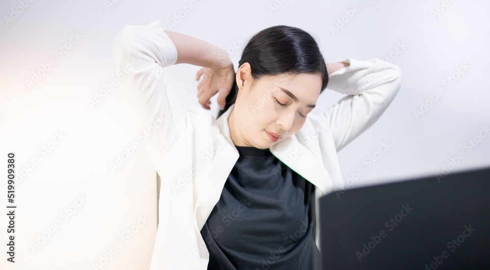 Asian young feeling painful from work, while sitting in front of the laptop in their home. Concept working woman office syndrome. Asian young feeling painful from work, while sitting in front of the laptop in their home. Concept working woman office syndrome.