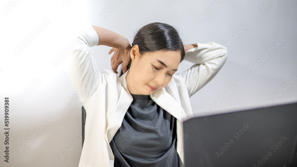Asian young feeling painful from work, while sitting in front of the laptop in their home. Concept working woman office syndrome. Asian young feeling painful from work, while sitting in front of the laptop in their home. Concept working woman office syndrome.