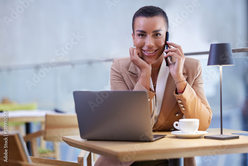 A businesswoman sits in a cafe and uses technologies to communicate with clients.