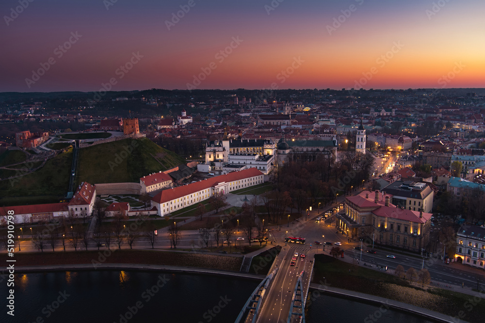 Scenic aerial view of Vilnius Old Town and Neris river at nightfall. Sunset landscape. Vilnius, Lithuania.