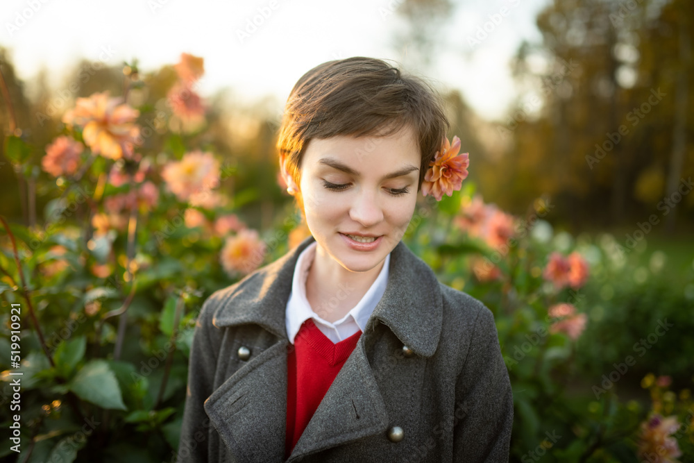 Beautiful teenage girl in blossoming dahlia field. Child picking fresh flowers in dahlia meadow on sunny autumn day. Beautiful teenage girl in blossoming dahlia field. Child picking fresh flowers in dahlia meadow on sunny autumn day.