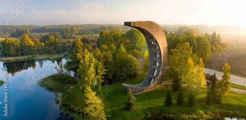 Amazing aerial view of Kirkilai karst lakes and lookout tower in the bright sunny autumn morning, Birzai, Lithuania photo