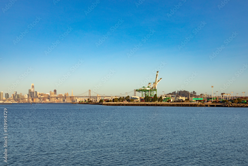 oakland harbor with container cranes in early morning light. Oakland serves as harbor for San Francisco