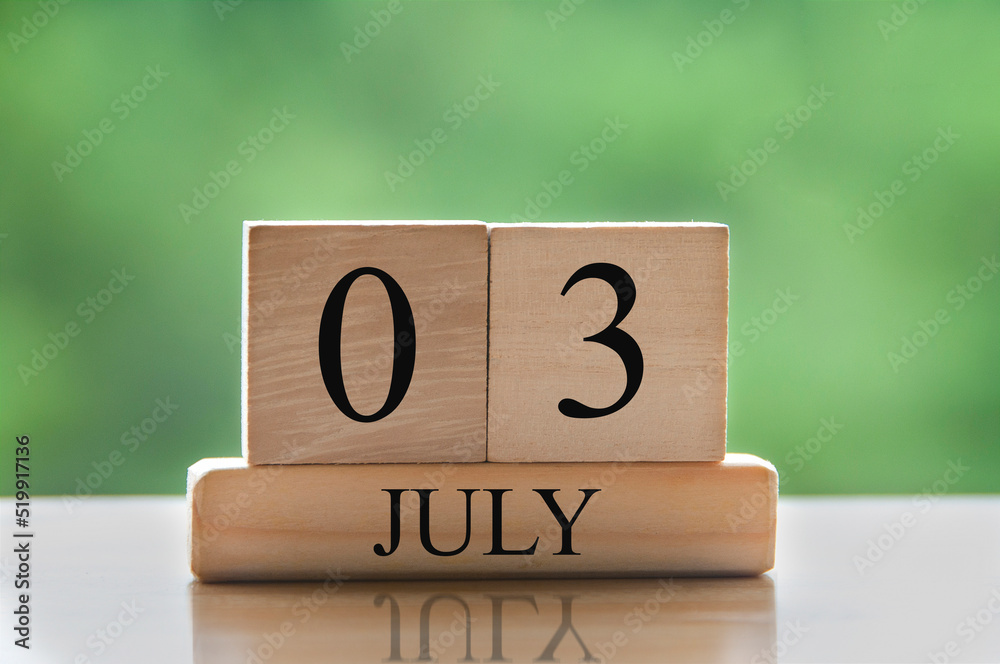 July 3 calendar date text on wooden blocks with blurred background park. Calendar concept July 3 calendar date text on wooden blocks with blurred background park. Calendar concept