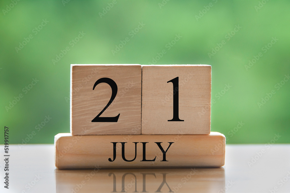 July 21 calendar date text on wooden blocks with blurred background park. Concept July 21 calendar date text on wooden blocks with blurred background park. Concept