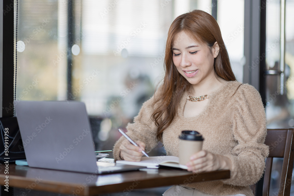 Freelancer Business asian woman or study online asian girl student having coffee and doing har work in cafe. Freelancer Business asian woman or study online asian girl student having coffee and doing har work in cafe.
