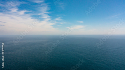 Blue ocean with waves and blue skies with clouds. Blue water and sky landscape, top view. Sri Lanka.