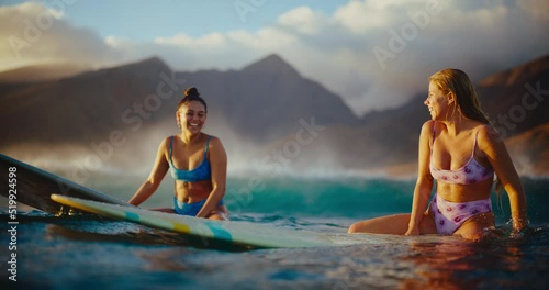 Girls surfing at sunset in Hawaii, smiling and waiting for the next wave, best friends surfing together, summer lifestyle
