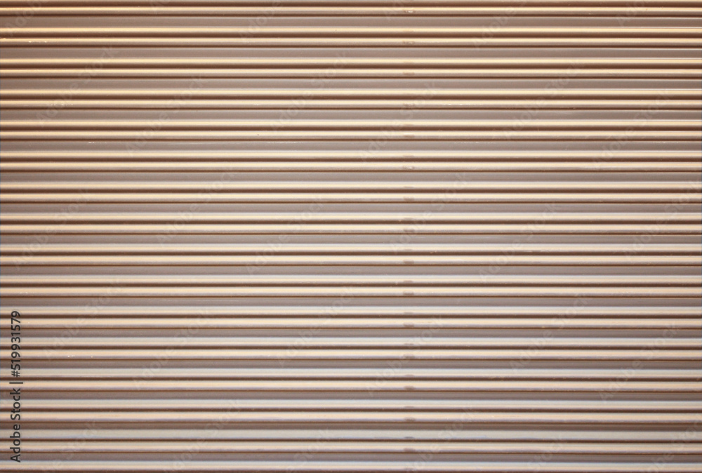 Corrugated metal roller shutter texture. Champagne gold steel door for background. Corrugated metal roller shutter texture. Champagne gold steel door for background.
