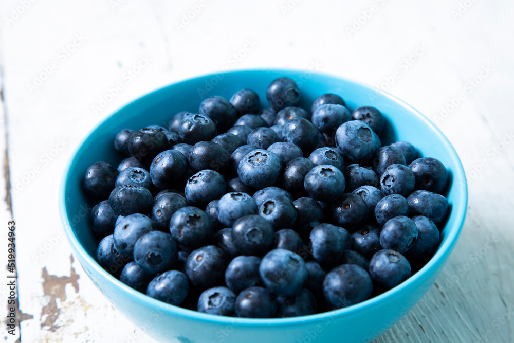 Blueberries in a blue bowl on a wooden table Blueberries in a blue bowl on a wooden table