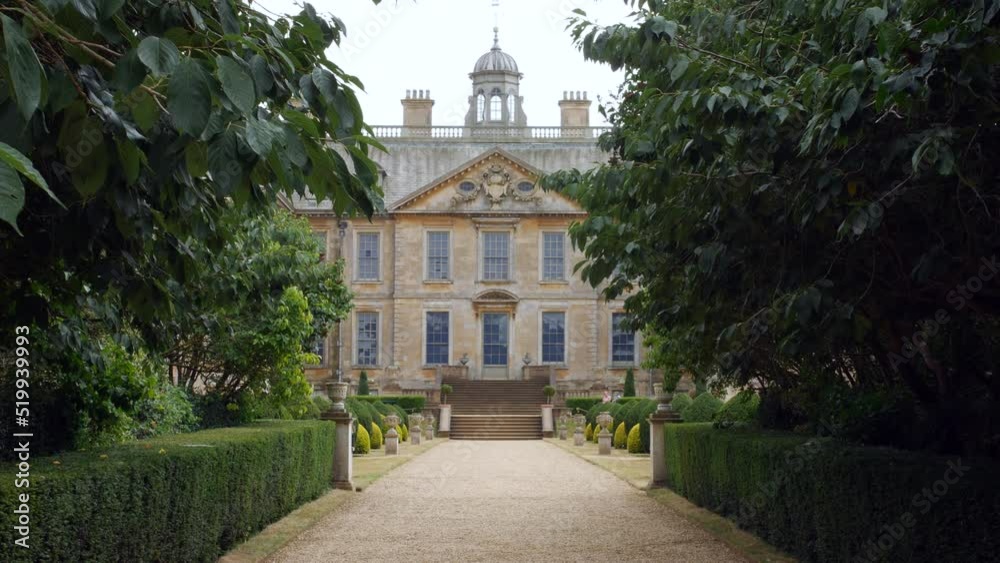 A grand manor house mansion palace stately home with gravel driveway with trees A grand manor house mansion palace stately home with gravel driveway with trees
