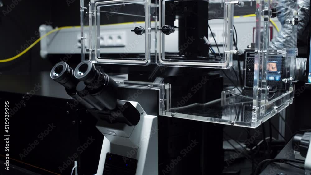 Pan up to a very modern digital microscope structure with very clean an sterile surfaces for scientific research Pan up to a very modern digital microscope structure with very clean an sterile surfaces for scientific research