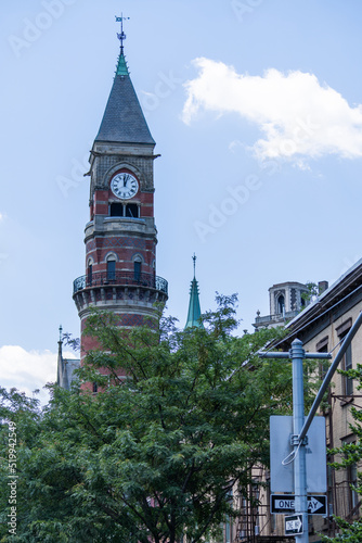 A clock towers rises above downtown Manhattan