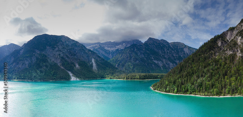 View from Top to the Austrian Plansee lake and its turquoise water and the deep green woods as a pure nature vacation spot