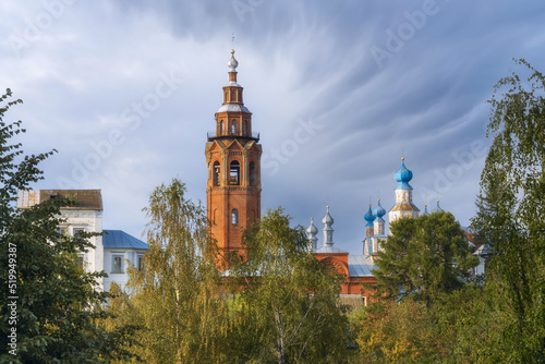 Old stone churches with high bell towers and blue domes in summer. Close-up. Cherdyn (Ural, Russia)