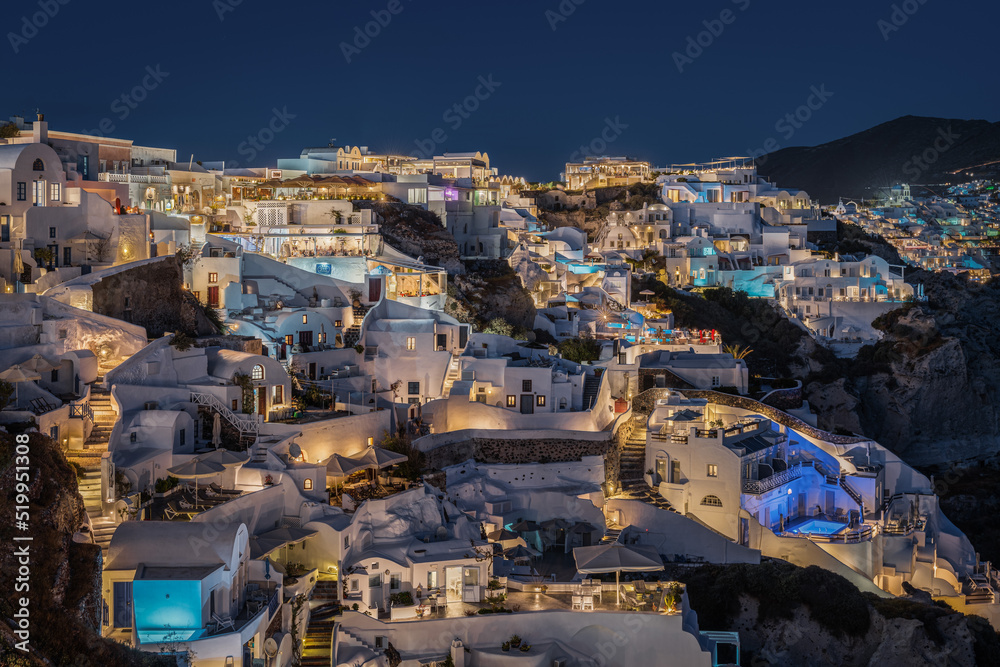 Scenic view at night of Oia village in Santorini, with its typical houses hosting suites e boutique hotels illuminated
