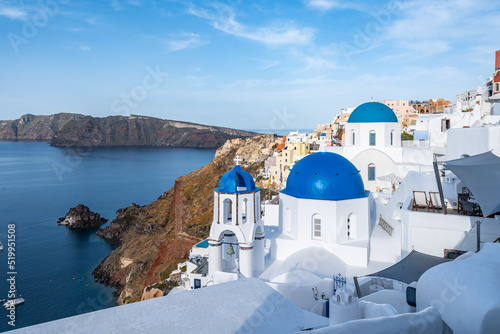 Fototapeta Naklejka Na Ścianę i Meble -  View of Oia in Santorini, the most famous village of the island with the typical white houses and blue domed churches