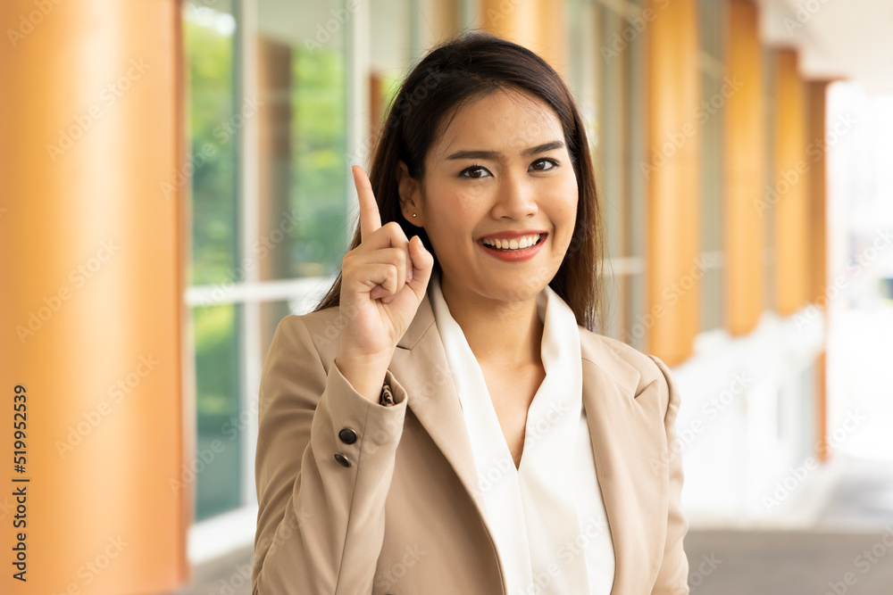Happy smiling office worker woman showing one finger for number 1 winning concept