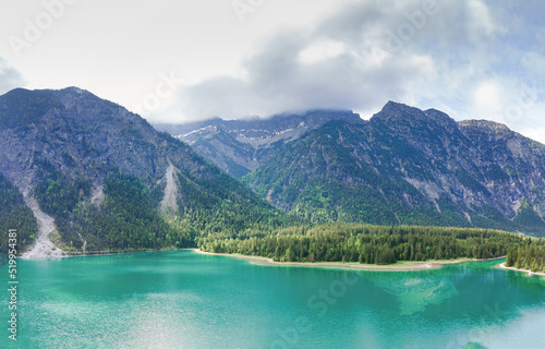 View from Top to the Austrian Plansee lake and its turquoise water and the deep green woods as a pure nature vacation spot