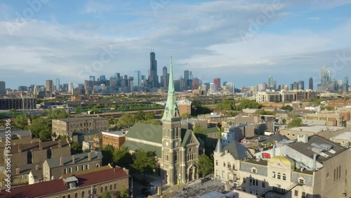 Cinematic Drone Shot Above Pilsen Neighborhood looking Downtown Chicago Skyline on Beautiful Summer Afternoon photo