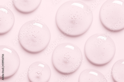 Pink drops of gel closeup. Cosmetic product for moisturizing the skin of the face or body. photo
