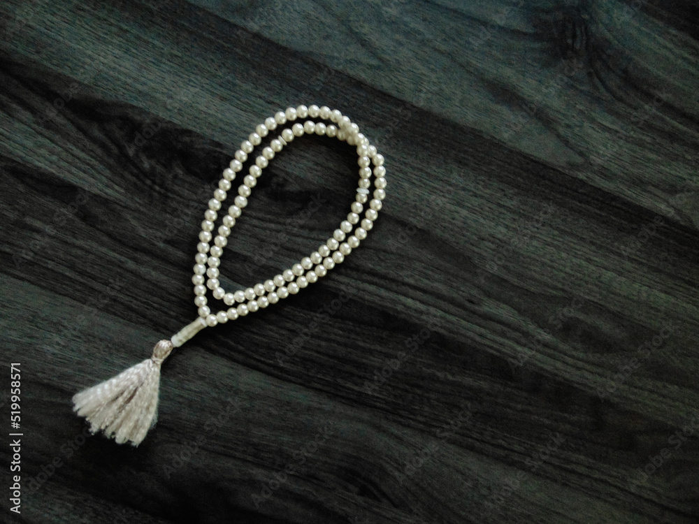 prayer beads on a wooden background