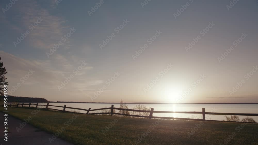 The morning sun rises over Lake Michigan as seen from the shore of Escanaba The morning sun rises over Lake Michigan as seen from the shore of Escanaba