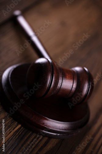 Gavel. Auction sale and business concept. Gavel and commercial code on the brown wooden background.