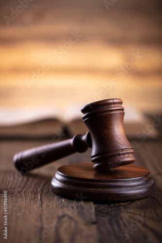 Gavel. Auction sale and business concept.  Gavel and commercial code on the brown wooden background.