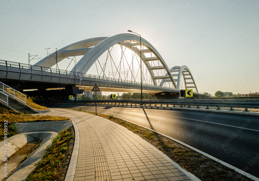 Fototapeta premium Novi Sad, Serbia. July - 25. 2022. Zezelj bridge on river Danube in Novi Sad. View of the Zezelje Bridge on the Danube in Novi Sad from the Petrovaradin side in the summer and in the afternoon.