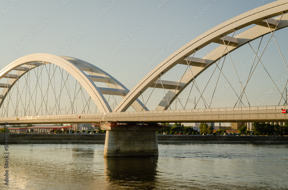 Novi Sad, Serbia. July - 25. 2022. Zezelj bridge on river Danube in Novi Sad. View of the Zezelje Bridge on the Danube in Novi Sad from the Petrovaradin side in the summer and in the afternoon. Novi Sad, Serbia. July - 25. 2022. Zezelj bridge on river Danube in Novi Sad. View of the Zezelje Bridge on the Danube in Novi Sad from the Petrovaradin side in the summer and in the afternoon.