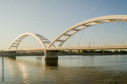Novi Sad, Serbia. July - 25. 2022. Zezelj bridge on river Danube in Novi Sad. View of the Zezelje Bridge on the Danube in Novi Sad from the Petrovaradin side in the summer and in the afternoon. © caocao191