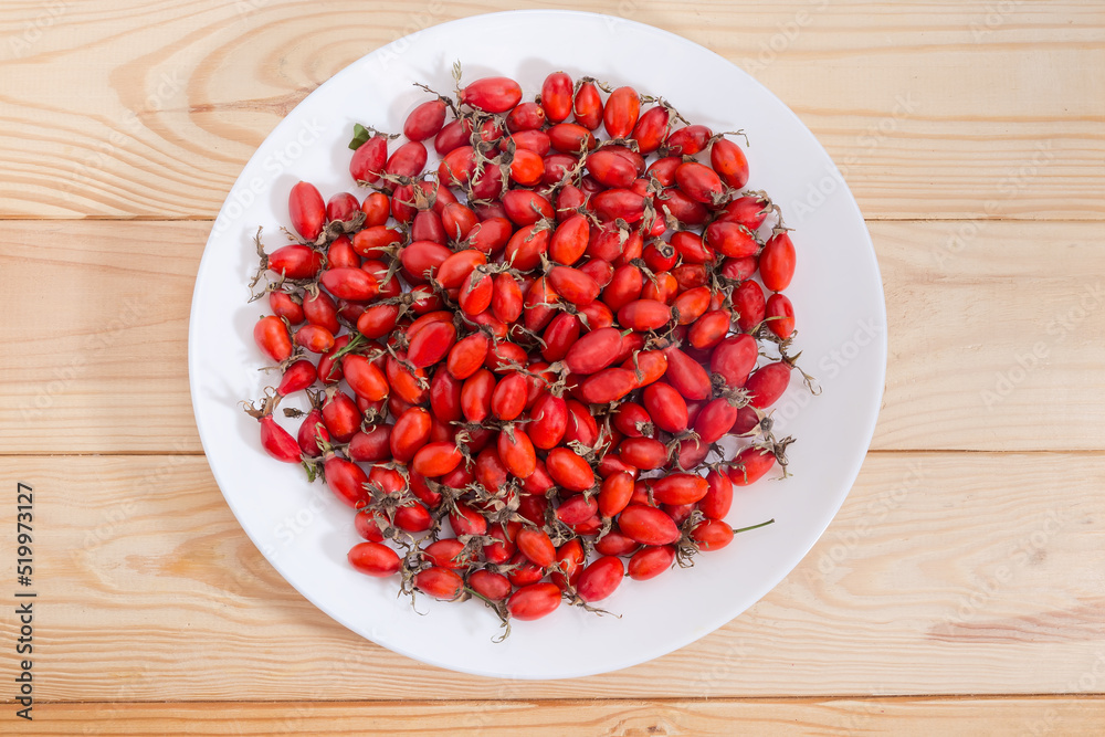 Top view of dry rose hips on dish on table