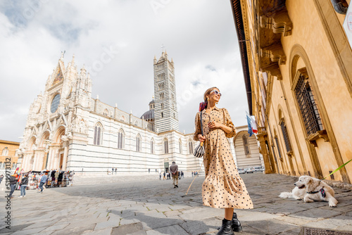 Woman standing in front of Siena cathedral. Traveling old towns of Tuscany region in Italy. Concept of visiting famous italian landmarks © rh2010