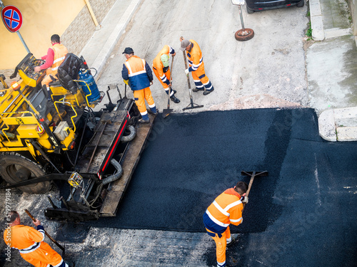 Obraz na plátne Worker on Asphalting paver machine during Road street repairing works