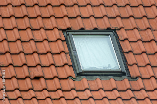 Single window in the brown attic roof