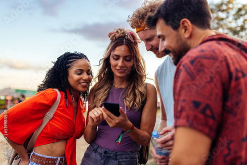 Four festival people using phone