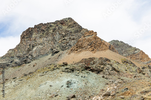 Excursion to the Gran Paradiso in the Alps. Search for rocks, minerals and precious stones. Study of the surface of rocks with sedimented debris over time. Lunar landscape, Martian landscape. © Mattia