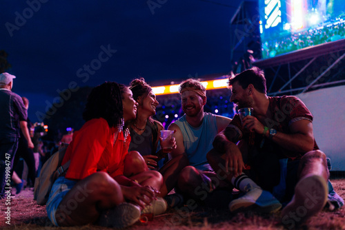 Four friends socializing at music festival © bernardbodo