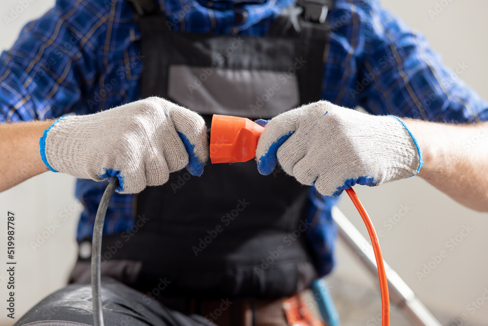 Connecting cables with a plug, extension cord plugging in construction
