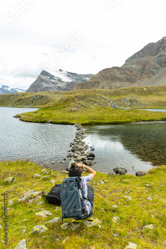  Excursion to the Gran Paradiso in the Alps. Stone walkway built into the water. A stone path that crosses the lake and connects to a small island of land.