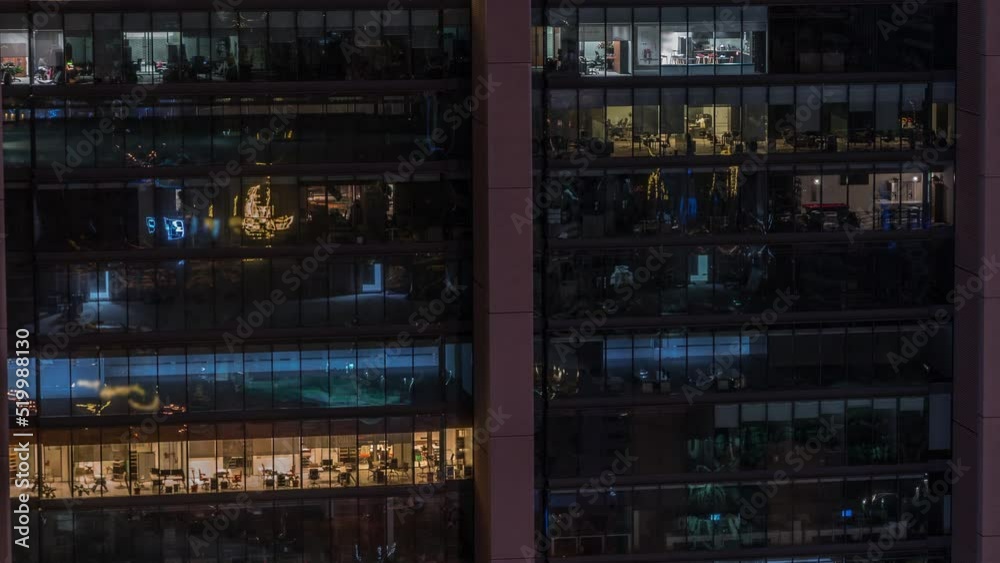 Big glowing windows in modern office and residential buildings timelapse at night, in rows of windows light shines. Work place in a skyscraper Big glowing windows in modern office and residential buildings timelapse at night, in rows of windows light shines. Work place in a skyscraper