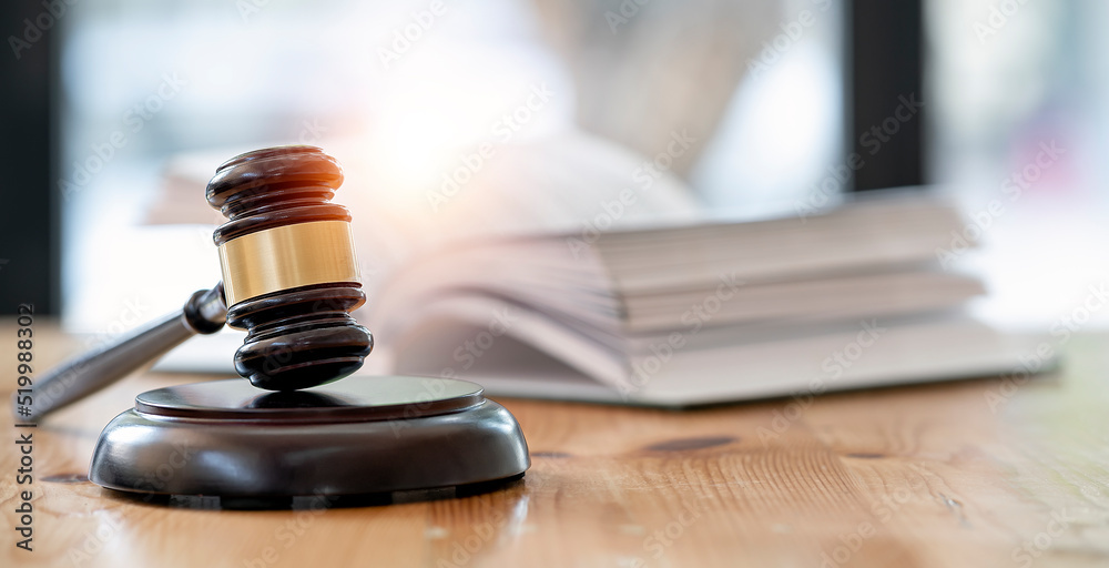 Wooden brown judge gavel on the table, copy space, banner background. Wooden brown judge gavel on the table, copy space, banner background.