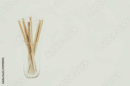 Bamboo straws in a glass against light grey background, perfect for customisation! Add Your Text, Logo, or Graphics to create stunning Presentations