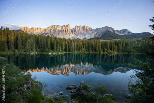 Fototapeta Naklejka Na Ścianę i Meble -  Splendid view of Lake Carezza in South Tyrol. The mountains and the forest are perfectly reflected on the lake, a suggestive image. A dream place for a relaxing holiday in nature.