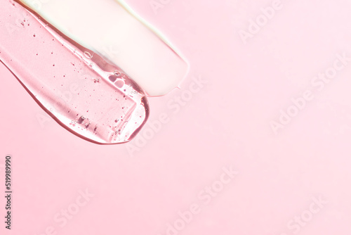 Various cosmetic mask, creams, serum, scrub and lotion smear on a pink background. Beauty texture. Sample of a cosmetic product. copy space for text