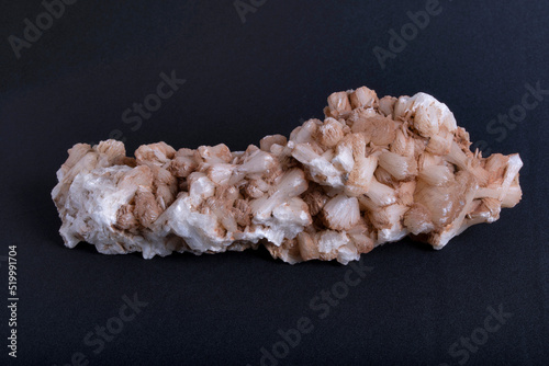 Closeup of Stilbite. Stilbite is a low-temperature secondary hydrothermal mineral. It occurs in the amygdaloidal cavities of basaltic volcanic rocks