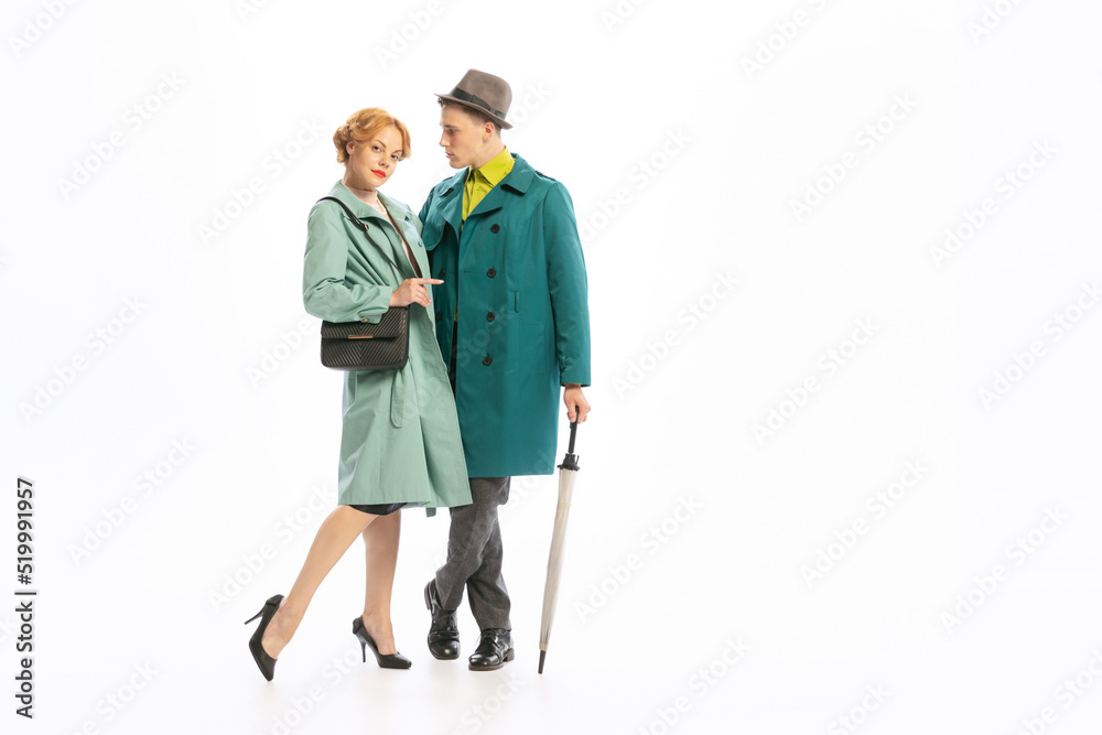 Portrait of stylish couple, man and woman in beautiful coats posing isolated over white background Portrait of stylish couple, man and woman in beautiful coats posing isolated over white background